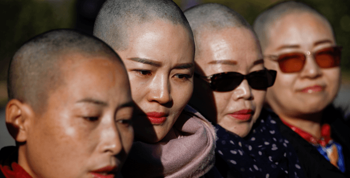 Chinese Wives Shave Heads in Protest