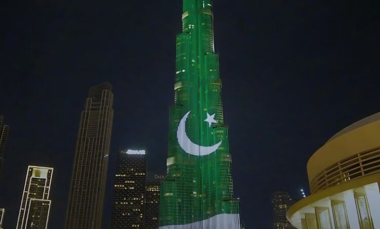 a tall building with a green and white moon and star